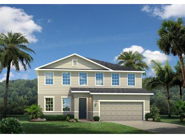 Beautiful two-story home featuring a well-manicured lawn and a two-car garage at 1309 Whispering Ln, Minneola, FL 34715