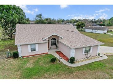 Charming single-story home featuring a well-maintained lawn and inviting walkway at 12 Almond Ter, Ocala, FL 34472