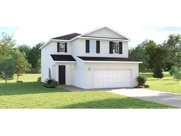 Charming two-story home with white siding, a two-car garage, and a well-manicured lawn at 5039 Bear Lake Loop, Deland, FL 32724