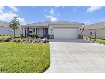 Charming single-story home with a well-manicured lawn and a spacious two-car garage at 8750 Sw 79Th Loop, Ocala, FL 34481