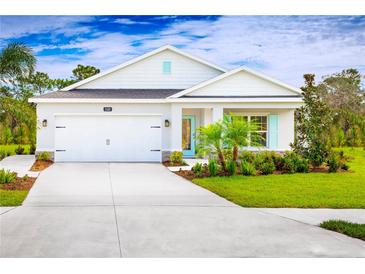 Charming single-story home with a well-manicured lawn and a bright blue front door at 4214 Cattail Marsh Dr, Lakeland, FL 33811