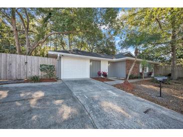 Charming single-story home with a well-maintained front yard, long driveway, and a one-car garage at 700 Crestwood Way, Winter Springs, FL 32708