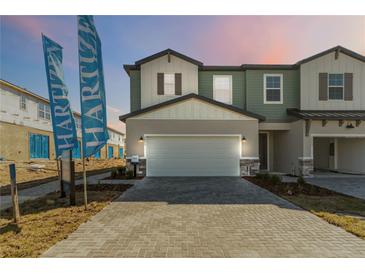 Charming two-story home featuring a spacious two-car garage and stylish architectural details at 1104 Desert Candle Dr, Ocoee, FL 34761