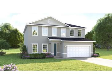 Charming two-story home with a well-maintained lawn, attached two-car garage, and a welcoming front entrance at 11054 Nellie Crossing Cir, Clermont, FL 34711