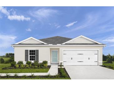 Charming single-story home with a two-car garage, blue front door, and well-manicured lawn at 403 Harvard Ct, Dundee, FL 33838