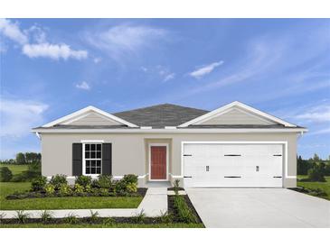Charming single-story home with a well-manicured lawn and inviting front entrance with a gray and white color scheme at 416 Harvard Ct, Dundee, FL 33838