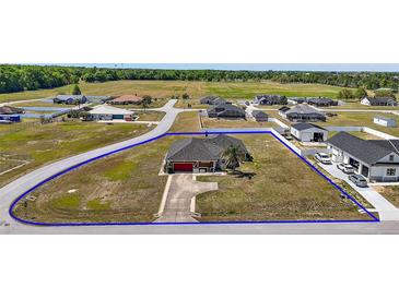 Spacious home with a well-maintained yard and a long driveway in a quiet neighborhood at 7355 Se 106Th Pl, Belleview, FL 34420