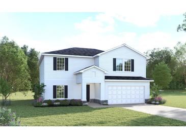 Charming two-story home featuring a manicured lawn, attached garage, and classic black and white design at 2146 Tennessee St, Sumterville, FL 33585