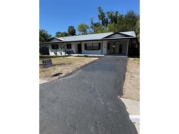 Charming single-story home featuring a newly paved driveway and metal roof at 601 Lantern Ln, Orange City, FL 32763