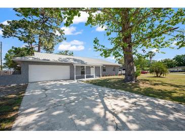 Charming single-story home with stone accents, a well-manicured lawn and a spacious two car garage at 201 Lake Gene Dr, Longwood, FL 32779