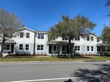 Charming two-story townhome with a well-manicured lawn and beautiful landscaping, perfect for comfortable living at 3309 Grande Heron Dr, St Cloud, FL 34773