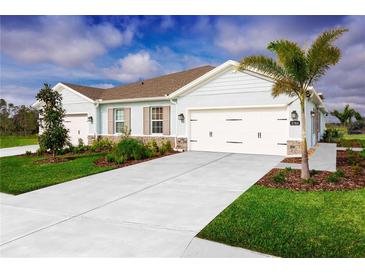 Charming single-story home featuring a three-car garage, well-manicured lawn, and stone accents at 1203 Turtle Island Rd, Lady Lake, FL 32159