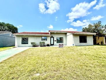 Charming single-story home featuring a red tile roof, well-maintained lawn and a 'For Sale' sign at 10859 William And Mary Ct, Orlando, FL 32821