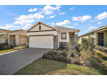 Charming single-story home featuring a landscaped yard, brick accents, and a two-car garage at 4106 Nw 44 Cir, Ocala, FL 34482
