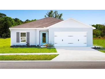 Charming single-story home featuring a colorful front door and well-manicured lawn at 420 Harvard Ct, Dundee, FL 33838
