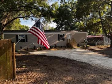 Charming single-story home featuring a well-manicured lawn and welcoming front entrance at 3346 Se 131St Pl, Belleview, FL 34420
