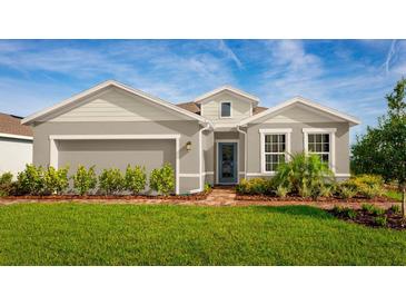 Charming single-story home with a well-manicured lawn and brick pathway leading to the front door at 11014 Nellie Crossing Cir, Clermont, FL 34711