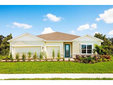 Charming single-story home with well-manicured lawn, tidy landscaping, and a decorative teal door at 1524 Covey Rise Ter, Winter Haven, FL 33884