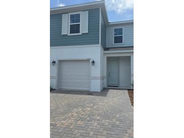 Charming two-story home featuring a one car garage and a neatly paved driveway at 1133 Red Buckeye Ct, Deland, FL 32720