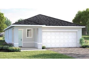 Charming single-story home with a two-car garage, landscaped front yard, and covered entry way at 6528 Domizio Dr, Winter Haven, FL 33884