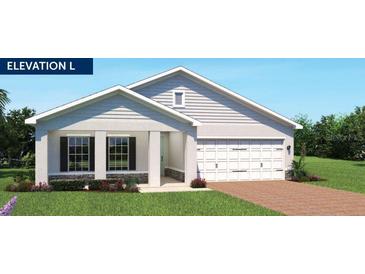Charming single-story home with a two-car garage, well-manicured lawn, and inviting front porch at 1373 Laramie Way, Haines City, FL 33844