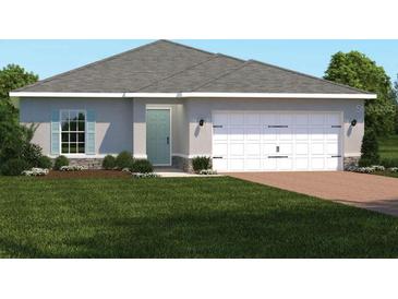 Charming single-story home with a manicured lawn and a two-car garage, offering curb appeal at 1408 Laramie Way, Haines City, FL 33844