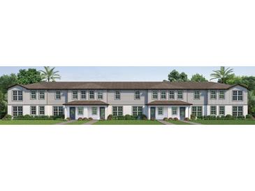 New two-story townhomes boast elegant neutral tones, covered front porches, and well-manicured landscaping at 741 Mystic Gardens Dr, Apopka, FL 32703
