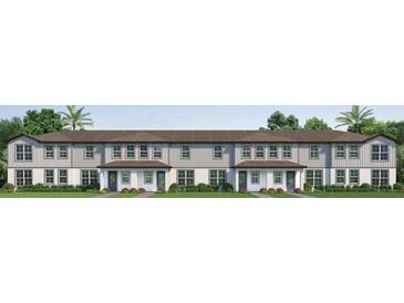 Charming townhome showcases a welcoming entrance with a lush, green lawn at 753 Mystic Gardens Dr, Apopka, FL 32703