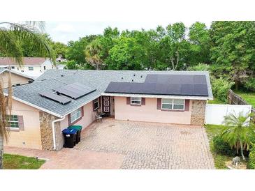 Charming single-story home featuring solar panels, brick accents, and a spacious brick driveway at 774 Hendrix Ave, Orlando, FL 32825