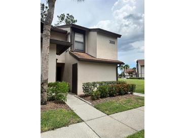 Inviting two-story exterior of this home featuring lush landscaping and a private entrance at 3006 S Semoran Blvd # 7, Orlando, FL 32822