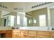Well-lit bathroom featuring a large vanity mirror and countertop space at 255 Royal Palm Dr, Davenport, FL 33837