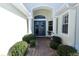 Inviting front entrance featuring a double door entry and manicured landscaping, creating a warm welcome at 255 Royal Palm Dr, Davenport, FL 33837