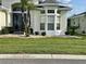 Well-maintained front yard with lush green grass, decorative rock, and mature landscaping at 255 Royal Palm Dr, Davenport, FL 33837