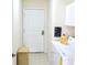 Bright laundry room with washer, dryer, cabinets, and ample storage space at 255 Royal Palm Dr, Davenport, FL 33837