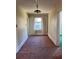 Hallway with a unique hanging light fixture and large window, providing ample light at 1116 W Line St, Leesburg, FL 34748