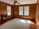 Living room with carpet and natural wood paneling at 1116 W Line St, Leesburg, FL 34748