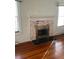 Living room features a classic fireplace and hardwood floors at 1116 W Line St, Leesburg, FL 34748