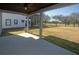 View from covered back patio of the expansive backyard and surrounding green space at 33953 Terragona Dr, Sorrento, FL 32776