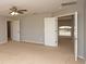 Carpeted bedroom with ceiling fan, closet, and light gray walls at 33953 Terragona Dr, Sorrento, FL 32776