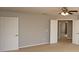 Carpeted bedroom features a ceiling fan and view to an open doorway at 33953 Terragona Dr, Sorrento, FL 32776