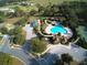 Aerial view of the community pool, tennis courts, and surrounding green spaces at 33953 Terragona Dr, Sorrento, FL 32776