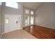 Bright foyer with tiled flooring transitioning to wood floors, a high ceiling, and many windows at 33953 Terragona Dr, Sorrento, FL 32776