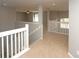 Upstairs hallway with neutral walls, carpet flooring, and white railing around the stairwell at 33953 Terragona Dr, Sorrento, FL 32776