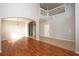 Bright and airy living room with hardwood floors, staircase, and neutral paint at 33953 Terragona Dr, Sorrento, FL 32776