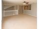 Large loft space featuring carpet flooring and a white railing overlooking the stairwell at 33953 Terragona Dr, Sorrento, FL 32776