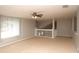 Spacious loft area with neutral walls, carpet flooring, and a large window at 33953 Terragona Dr, Sorrento, FL 32776