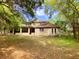 Back view of charming two-story house with a screened-in porch and a well-manicured lawn at 850 Eden Dr, Saint Cloud, FL 34771