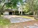 Charming two-story home with stucco exterior, attached garage and long driveway surrounded by mature trees at 850 Eden Dr, Saint Cloud, FL 34771