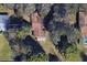 Close-up aerial view of the house showcasing its roof and landscaping within the residential area at 3240 Flamingo Ln, Mulberry, FL 33860