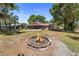 Open fire pit surrounded with brick and concrete blocks in the backyard at 3240 Flamingo Ln, Mulberry, FL 33860